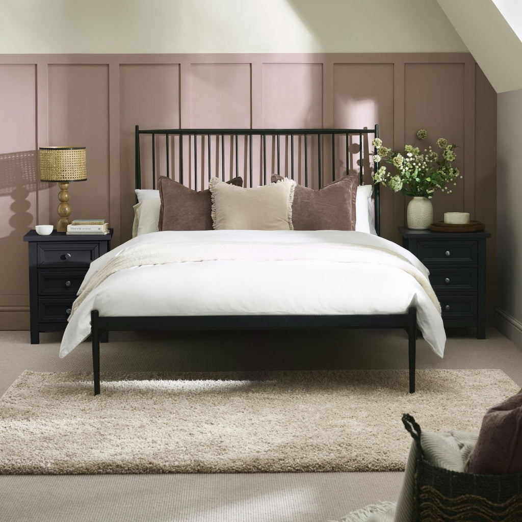 Flyde black metal spindle bed frame in a bedroom