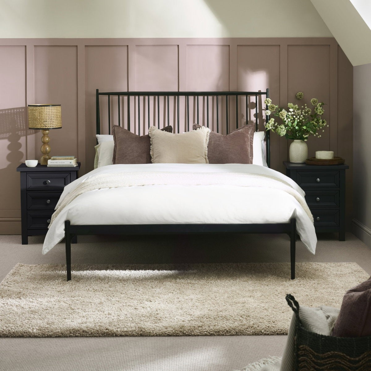 Flyde black metal spindle bed frame in a bedroom