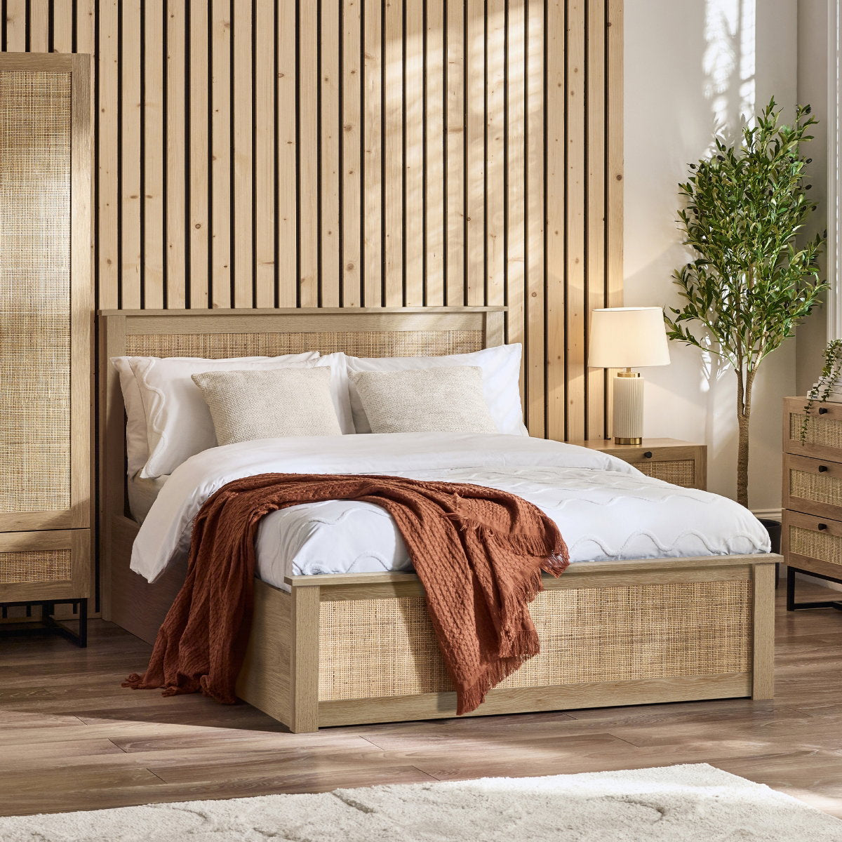 Paddy Oak Rattan King Size Ottoman Bed in a bedroom